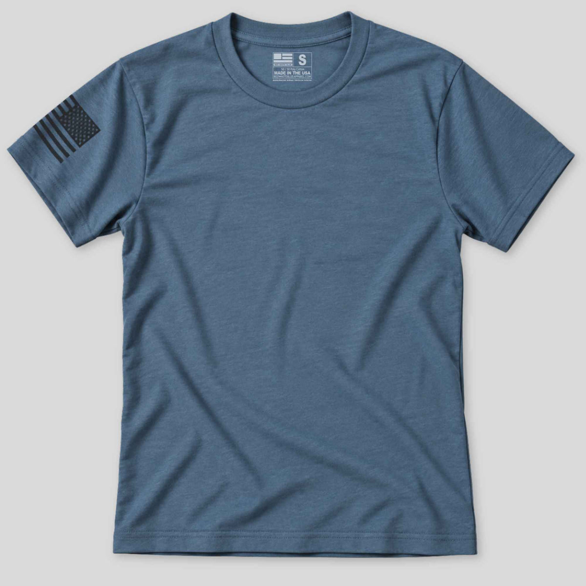 A heathered slate blue crewneck t-shirt with a black distressed American flag patch on the right sleeve, displayed flat against a light gray background.