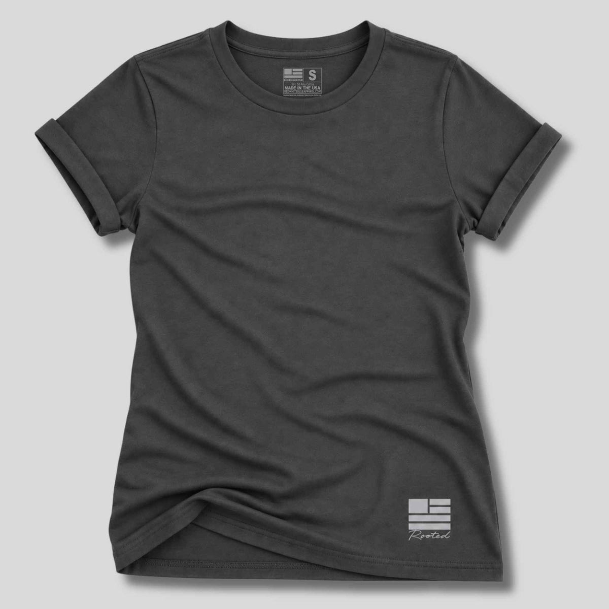 A dark charcoal gray short-sleeve t-shirt with a small white graphic logo on the bottom right, displayed on a neutral light gray background.