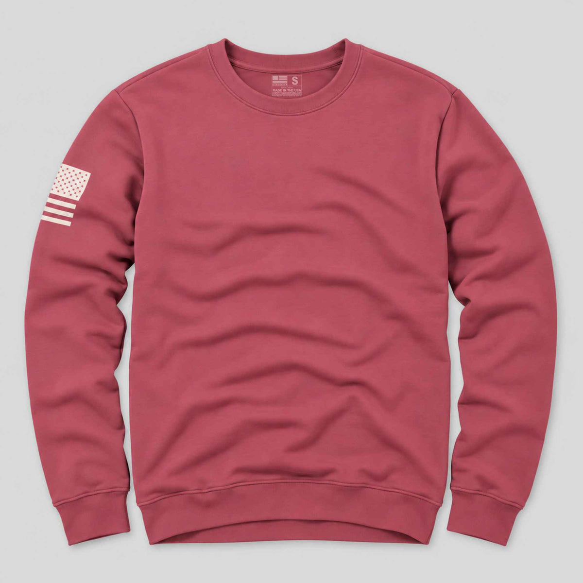 An American flag crew neck sweatshirt laying flat on a gray background proudly made in the usa