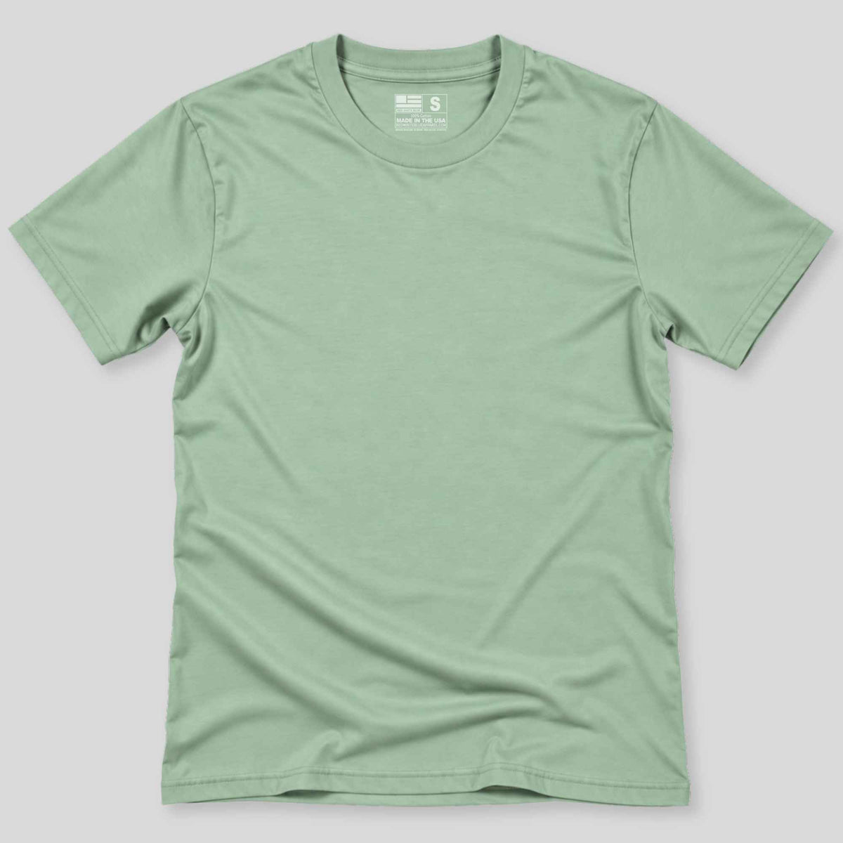 A light sage green crewneck t-shirt laid flat against a neutral gray background.