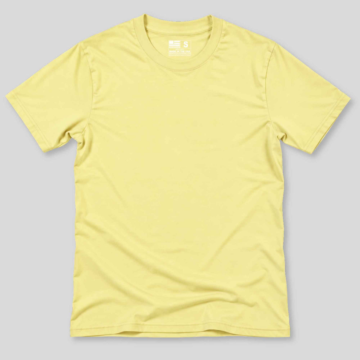 A light yellow short-sleeve crewneck t-shirt laid flat against a solid gray background.