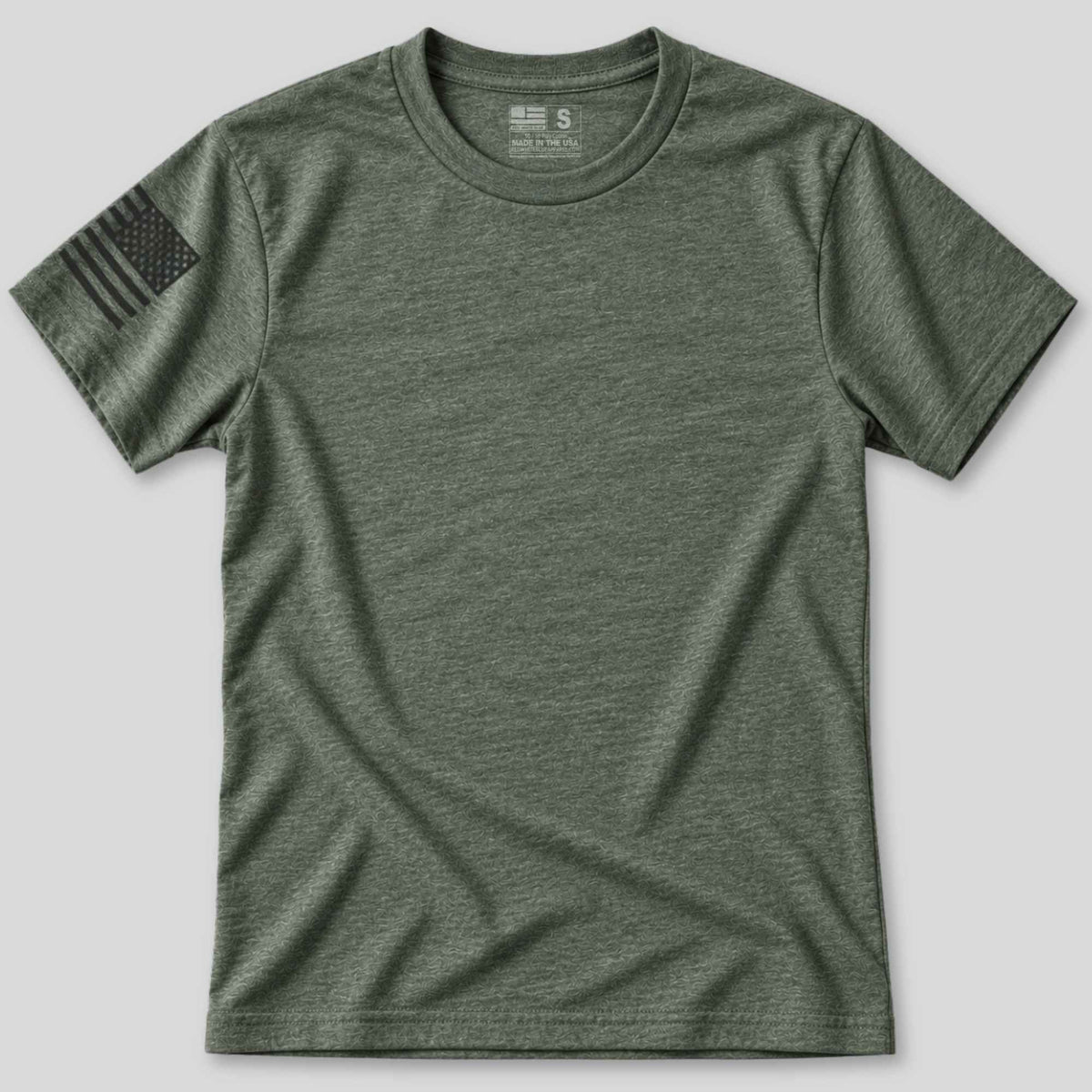 An olive green heather short-sleeve crewneck t-shirt with a black American flag graphic printed on the left sleeve, displayed flat against a light gray background.