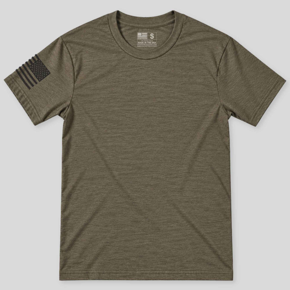 An olive green short-sleeve crewneck t-shirt with a black distressed American flag graphic on the right sleeve, displayed flat against a light gray background.