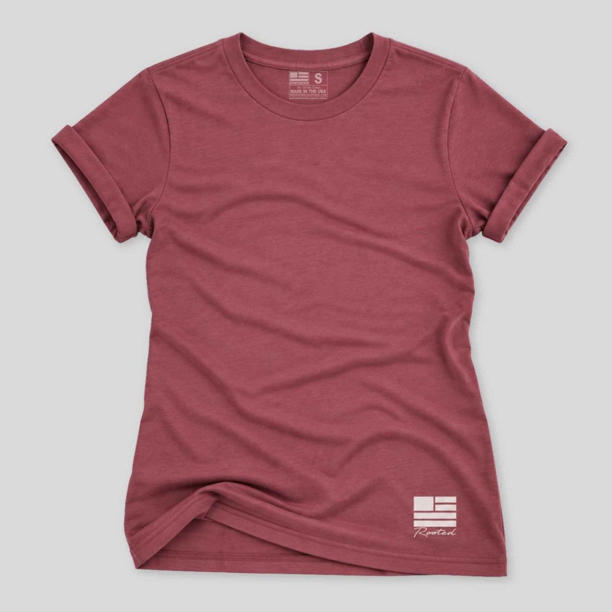 A women's short-sleeve crewneck t-shirt in heathered dusty rose, featuring a white printed logo on the bottom right and a size tag on the inside neck, laid flat on a light gray background.