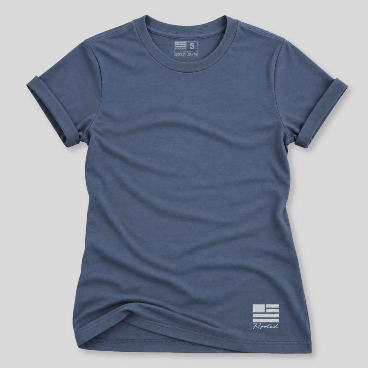 A slate blue short-sleeve crewneck t-shirt with a small white Greek flag and 'Kyptral' logo printed on the bottom right, displayed flat against a light gray background.